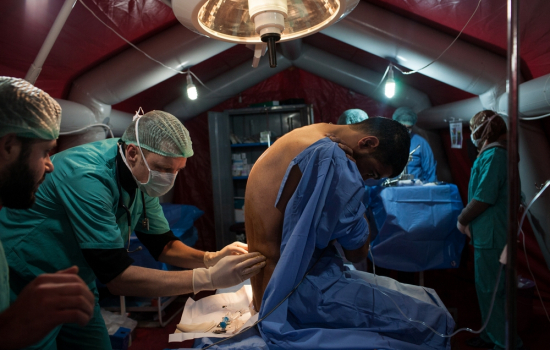 Mohamed, is examined by German anesthetist Hans Gerber of MSF before undergoing surgery to remove a bullet lodged in his abdomen at the MSF clinic in Northern Syria, on Thursday, January 31, 2013.